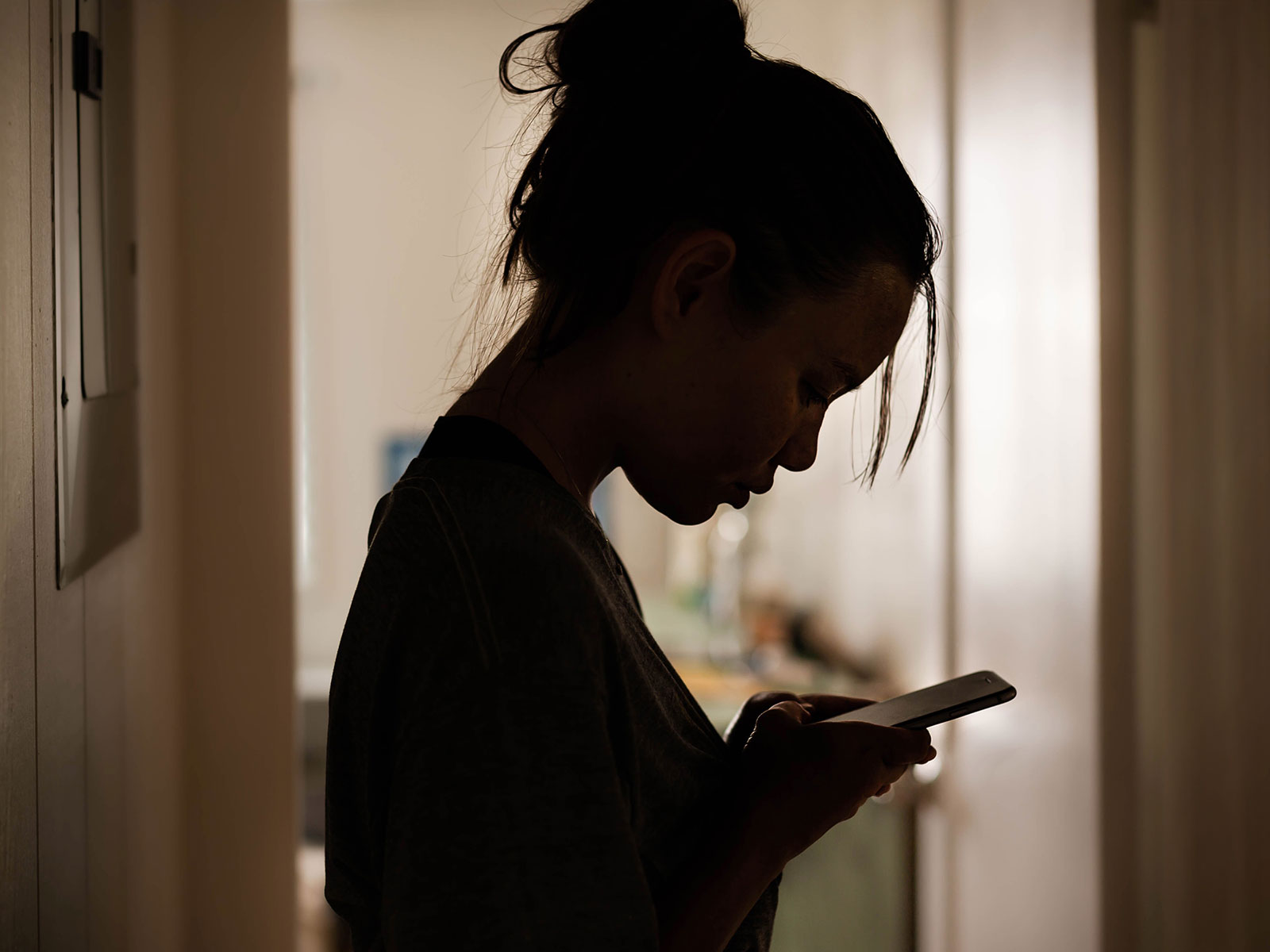 A young woman looking at her phone.